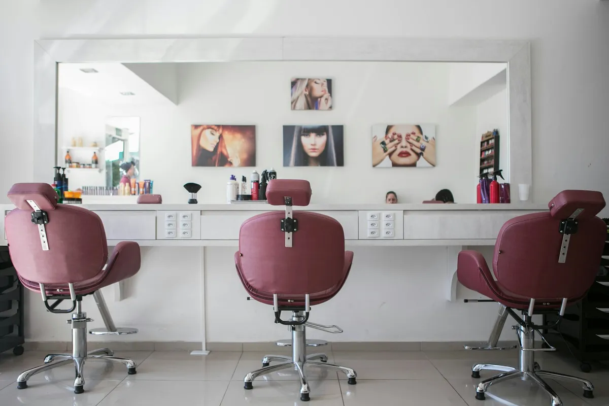 A longtime regular getting a haircut in a classic neighborhood barbershop.